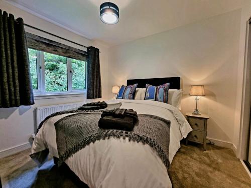 a bedroom with a large bed and a window at Shoreside Villa - immaculate waterfront property in Skelmorlie in Skelmorlie