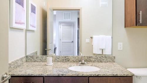 a bathroom with a sink and a mirror at Landing - Modern Apartment with Amazing Amenities (ID8201X09) in Orlando