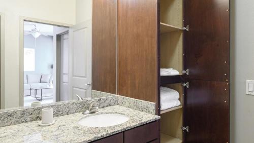 a bathroom with a sink and a mirror at Landing - Modern Apartment with Amazing Amenities (ID8201X11) in Orlando