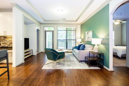 a living room with a couch and a bed at Landing - Modern Apartment with Amazing Amenities (ID3752) in Atlanta