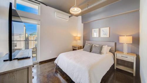 a bedroom with a bed and a large window at Landing - Modern Apartment with Amazing Amenities (ID7845X46) in Sparks