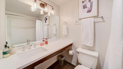a white bathroom with a sink and a toilet at Landing - Modern Apartment with Amazing Amenities (ID7845X46) in Sparks