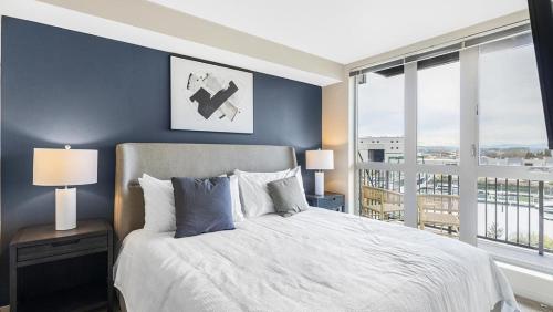 a bedroom with a large bed and a large window at Landing Modern Apartment with Amazing Amenities (ID8925X56) in Tacoma