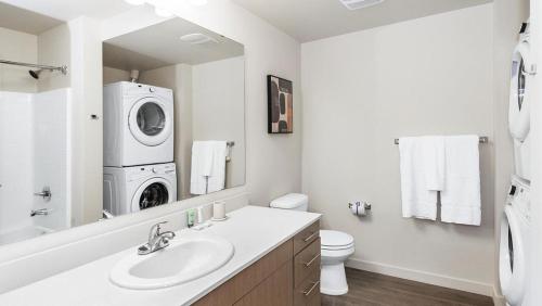 a bathroom with a sink and a washing machine at Landing Modern Apartment with Amazing Amenities (ID8925X56) in Tacoma