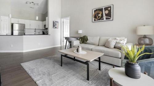 a living room with a couch and a table at Landing - Modern Apartment with Amazing Amenities (ID1374X806) in Charlotte
