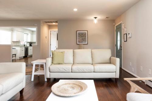a living room with a couch and a table at The VIBE House with POOL in Virginia Beach