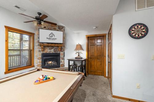 a room with a pool table and a fireplace at Deer Valley in Branson