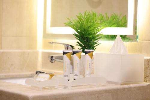 a bathroom counter with a sink with books on it at Cheney Parkin in Taif