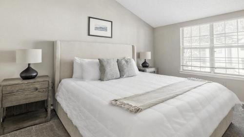 een witte slaapkamer met een groot bed en een raam bij Landing - Modern Apartment with Amazing Amenities (ID1182X728) in College Park