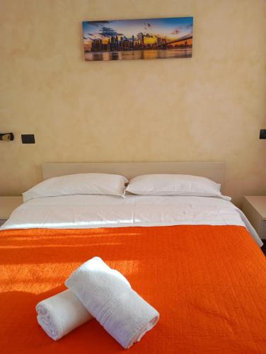 a bedroom with a bed with two towels on it at T'Addormento in Reggio di Calabria