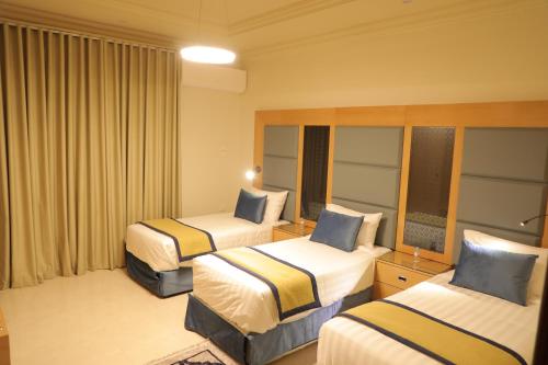 a hotel room with two beds and curtains at Cheney Parkin in Taif