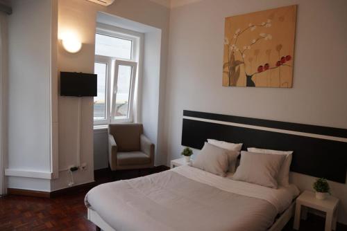 a bedroom with a large bed and a chair at Bisengototo Homestay in Lisbon