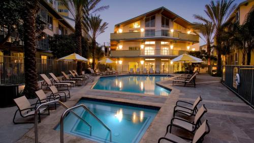 a swimming pool with chairs and a building at The tulip Marina Highrise with ocean view in Los Angeles