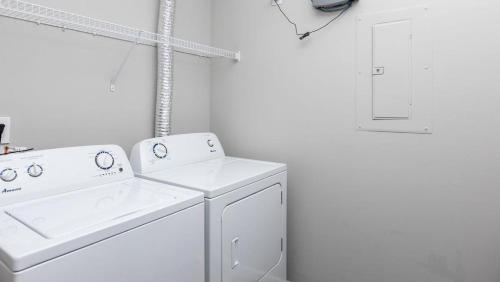 a white laundry room with a washer and dryer at Landing - Modern Apartment with Amazing Amenities (ID8193X50) in Columbus