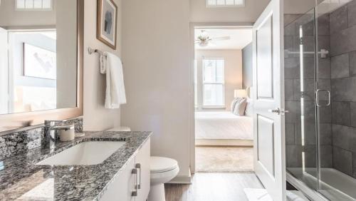 a bathroom with a sink and a toilet and a shower at Landing - Modern Apartment with Amazing Amenities (ID8375X72) in Middleburg