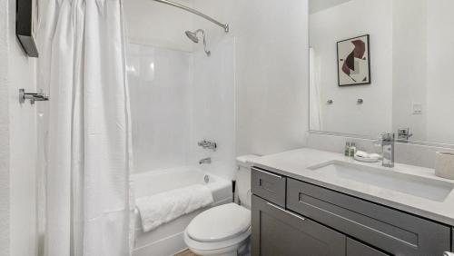 a white bathroom with a toilet and a sink at Landing - Modern Apartment with Amazing Amenities (ID7827X62) in Redondo Beach
