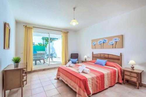 a bedroom with a bed and a view of the ocean at Villa Cati Punta Prima in Punta Prima