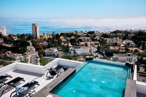 a swimming pool on the roof of a building at HO Aguadulce in Aguadulce