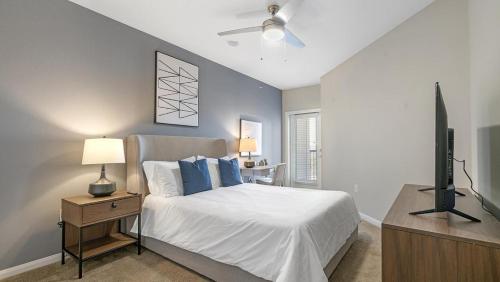 a bedroom with a bed and a flat screen tv at Landing - Modern Apartment with Amazing Amenities (ID8830X56) in San Antonio