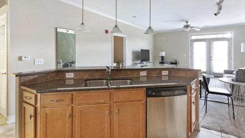 a kitchen with a sink and a dishwasher at Landing - Modern Apartment with Amazing Amenities (ID1285X345) in Greensboro