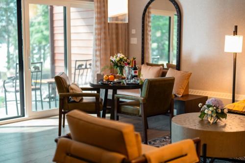 a living room with a table and chairs at Fairmont Jasper Park Lodge in Jasper