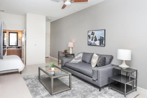 a living room with a couch and a table at Landing - Modern Apartment with Amazing Amenities (ID2654) in Tampa