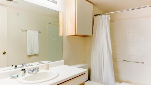 a bathroom with a sink and a shower curtain at Landing - Modern Apartment with Amazing Amenities (ID9354X35) in Albuquerque