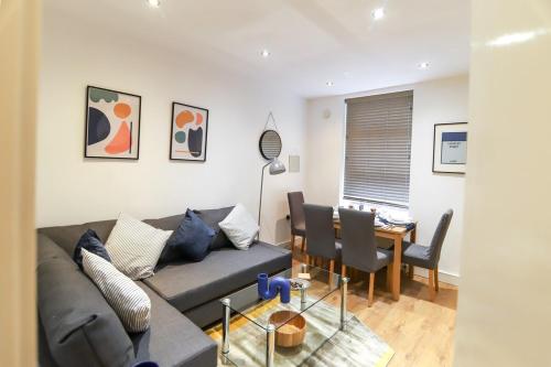 a living room with a couch and a table at New- Modern 2br Apt Wifi Sleep5 City Centre in Sheffield