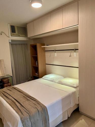 a bedroom with a large white bed in a room at Gavoa Resort Flat - Mar Doce Lar in Igarassu
