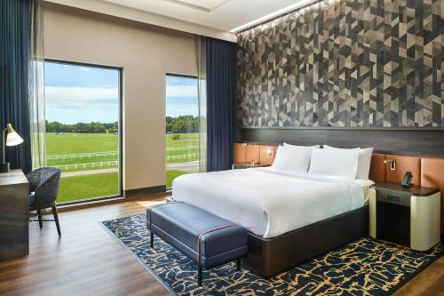 a bedroom with a bed and a desk and a window at SpringHill Suites by Marriott Franklin Mint in Franklin