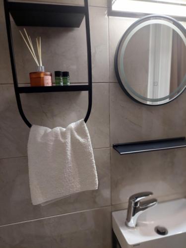 a bathroom with a mirror and a white towel at Αvra Strymonikou in Stavros
