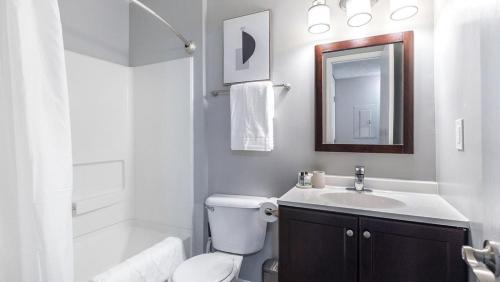 a white bathroom with a toilet and a sink at Landing - Modern Apartment with Amazing Amenities (ID9303X46) in Lewis Center
