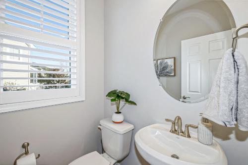 a bathroom with a sink and a toilet and a mirror at The Peninsula --- 24647 Navigators Walk in Millsboro