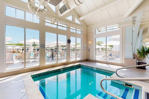 a swimming pool in a large room with windows at The Peninsula --- 24647 Navigators Walk in Millsboro