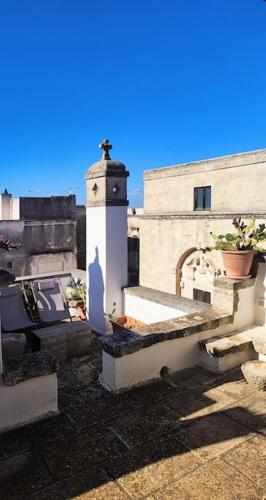 a cross on the side of a building with a church at Casa Mea in Grottaglie