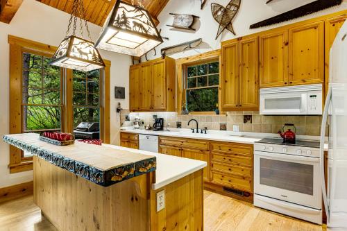a kitchen with wooden cabinets and white appliances at 3137 Arrowhead in Teton Village