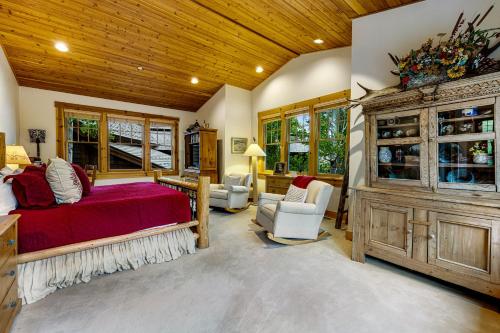 a bedroom with a bed and a wooden ceiling at 3137 Arrowhead in Teton Village