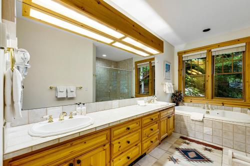 a bathroom with a tub and a sink and a tub and a tub at 3137 Arrowhead in Teton Village