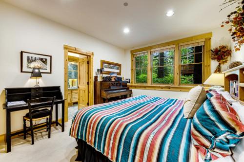 a bedroom with a bed and a desk and a piano at 3137 Arrowhead in Teton Village