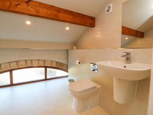 a bathroom with a sink and a toilet at Hill Brook Barn in Clitheroe