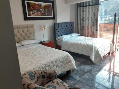 1 Schlafzimmer mit 2 Betten, einem Stuhl und einem Fenster in der Unterkunft HOTEL REAL PALACE CHURIN in Churín