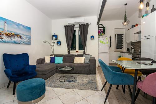 ein Wohnzimmer mit einem Sofa, einem Tisch und Stühlen in der Unterkunft Spacious Apartment Center in Split