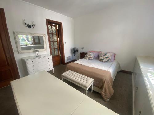 a bedroom with two beds and a dresser and a mirror at Habitación en Grand Maison en Alto Palermo in Buenos Aires