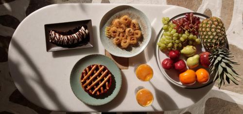 a white table topped with different types of food at Iria Beach Art Hotel in Agia Anna Naxos