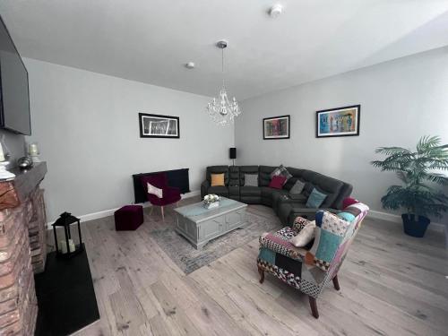 a living room with a couch and a table at The Old School House *New* in Coagh