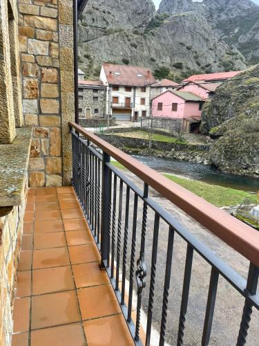 a balcony with a view of a river and buildings at Moradas Portilla in Portilla de la Reina
