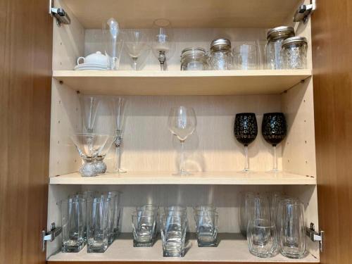 a cupboard filled with lots of empty glasses at Luxury Oasis Residence in Honolulu