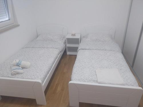 two beds in a small room with at Milica in Trebinje