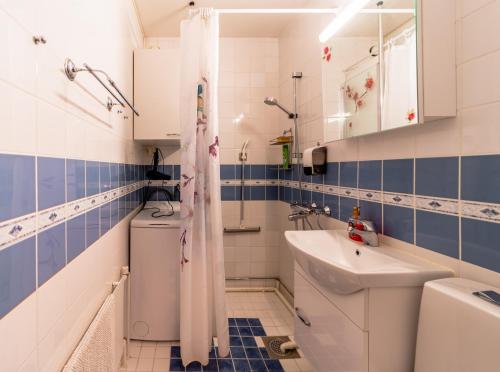 a bathroom with a toilet and a sink at Central Studio Apartment in Pori