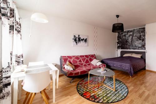 a living room with a couch and a table at Central Studio Apartment in Pori